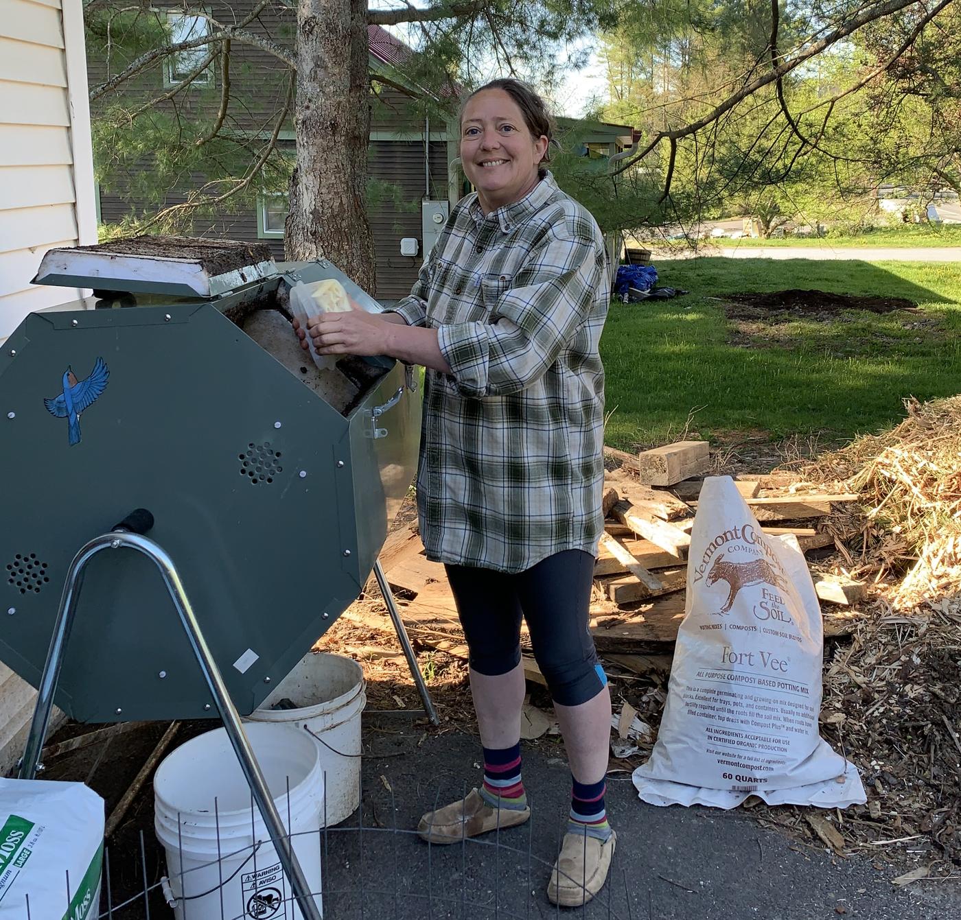 Emmanuelle adding food scraps to the tumbler